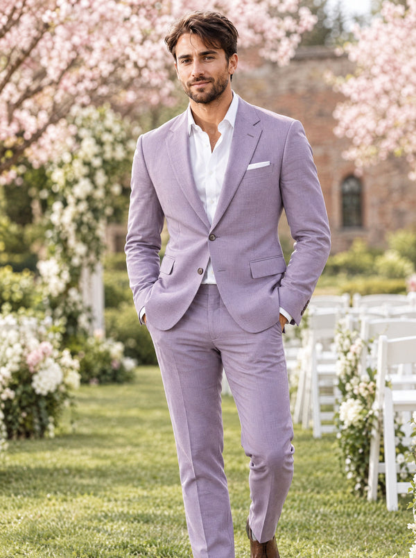 Groom in a lavender two-piece slim fit suit with white shirt at a spring garden wedding with cherry blossoms